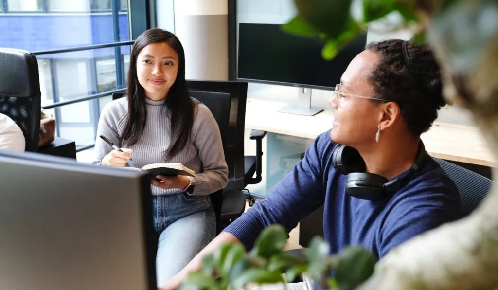 Simple meetings case study - people taking notes in meeting